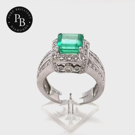  emerald cut natural emerald weight of 2.60ct. The emerald is encircled by 44 diamonds 1.30mm to 1.60mm .30cta further baguette cut diamonds total .50ct  These diamonds are graded as H/I VS to SI. The ring is mounted in 18ct white gold